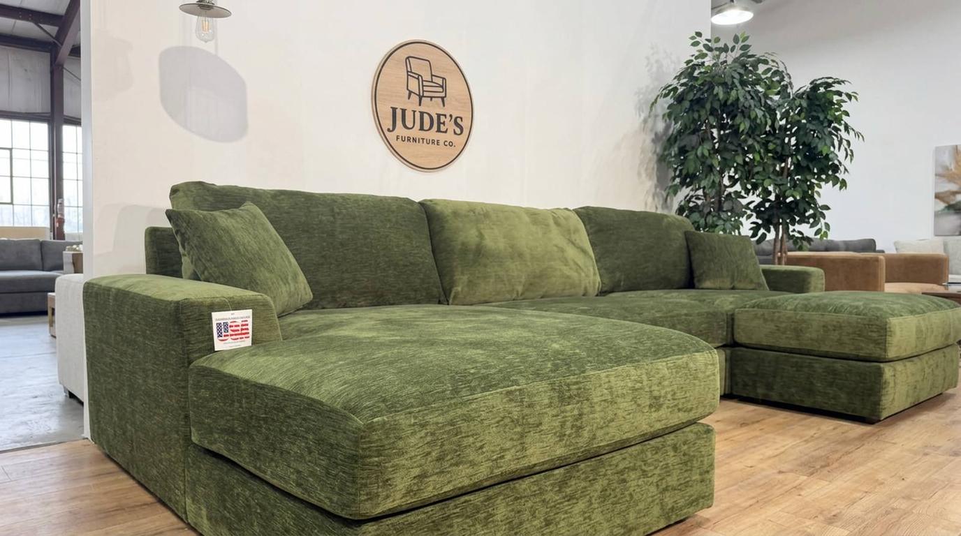 Green chenille modular sectional on the floor of the Jude's Furniture Co. warehouse in Fuquay-Varina